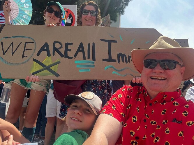 My family holding a "We are all Immigrants" sign.